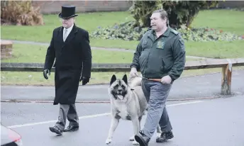  ??  ?? Michael’s dog Simba leads the funeral procession.