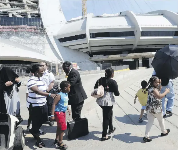  ?? RYAN REMIORZ / THE CANADIAN PRESS ?? Officials have opened up Montreal’s Olympic Stadium to shelter the wave of Haitian refugee claimants that have crossed into Canada from the U.S.