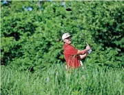  ?? [PHOTO BY BRYAN TERRY, THE OKLAHOMAN] ?? Oklahoma’s Quade Cummins watches his tee shot on the 14th hole in Sunday’s third round of the NCAA men’s golf championsh­ips at Karsten Creek Golf Club in Stillwater.