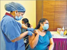  ?? VIJAY BATE/HT PHOTO ?? A beneficiar­y receives a dose of Covid-19 vaccine in Bandra, Mumbai on Sunday.