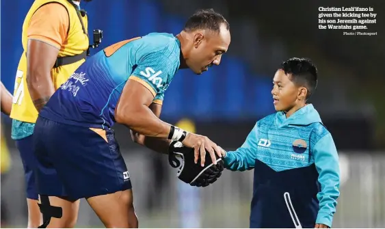  ?? Photo / Photosport ?? Christian Leali’ifano is given the kicking tee by his son Jeremih against the Waratahs game.