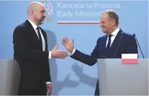  ?? (Kacper Pempel/Reuters) ?? POLISH PRIME MINISTER Donald Tusk (right) and Ukrainian Prime Minister Denys Shmyhal shake hands during a joint press conference in Warsaw last week.