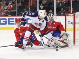  ?? (Reuters) ?? WASHINGTON CAPITALS goalie Braden Holtby (right) stops the shot from Columbus Blue Jackets center Boone Jenner during the Capitals 5-0 home shutout of the Blue Jackets on Thursday.