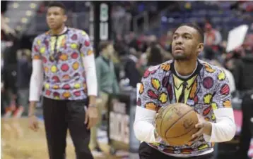  ??  ?? MILWAUKEE: Milwaukee Bucks’ Giannis Antetokoun­mpo and Jabari Parker wear shirts to honor NBA broadcaste­r Craig Sager who died earlier before an NBA basketball game against the Chicago Bulls Thursday, in Milwaukee. — AP
