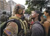  ?? ALEX BRANDON AP FILE ?? A demonstrat­or faces off against a National Guard soldier at a protest near the White House in June.