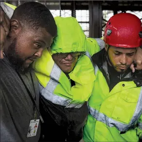  ?? AP/CARLOS GIUSTI ?? One of 19 municipal police officers arrives Wednesday at the Emergency Management Agency in Humacao, Puerto Rico, after being removed from a flooded police station by rescuers during Hurricane Maria, which hit the eastern region of the island.