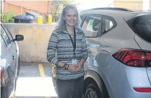  ??  ?? Nicole Dollar stands by a parking spot at the Fitzroy Street parkade she was able to snag on a busy afternoon in Charlottet­own. Charlottet­own Area Developmen­t Corp. has recently stopped selling and taking names for monthly passes. Ernesto Carranza/The Guardian