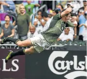  ?? /AFP ?? Flight risk: Ruhan Nel flies over to score in extra time to beat the US in the semifinal in Hong Kong on Sunday.