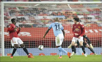  ??  ?? Fernandinh­o scores the second goal for Manchester City as Pep Guardiola’s side progressed at Old Trafford