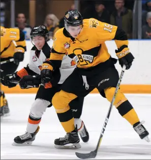  ?? MEDICINE HAT NEWS PHOTO RYAN MCCRACKEN ?? Brandon Wheat Kings winger Rylan Bettens and Medicine Hat Tigers centre Jaeger White battle for the puck during Game 5 of the Western Hockey League's Eastern Conference quarter-final series on Friday at Canalta Centre.