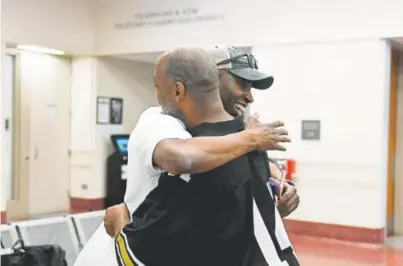  ?? Photos by Joe Amon, The Denver Post ?? Black Lives Matter 5280 activist Vincent Bowen, left, and Denver resident Alfred Sisco hug after Sisco’s release Thursday from the Downtown Detention Center.