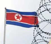  ?? REUTERS ?? A North Korea flag flutters next to concertina wire at the North Korean embassy in Kuala Lumpur, Malaysia.