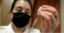  ?? MATT sTONE / hErALd sTAff fILE ?? FILLING THOSE NEEDLES: A paramedic for Brewster Ambulance fills a needle with the Pfizer vaccine during the Last Mile Vaccine Delivery and Get Out The Vax clinic at Emiliana Fiesta in Chelsea on April 27.