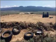  ?? MORGAN LEE — THE ASSOCIATED PRESS ?? A makeshift shooting range stands adjacent to a disheveled living compound in Amalia, N.M., on Tuesday. A New Mexico sheriff said searchers have found the remains of a boy at the makeshift compound that was raided in search of a missing Georgia child.