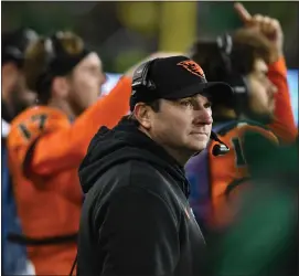  ?? MARK YLEN — THE ASSOCIATED PRESS ?? Oregon State coach Jonathan Smith looks up at the scoreboard during the second half of the team’s NCAA college football game against Oregon on Friday, Nov. 24, 2023, in Eugene, Ore.