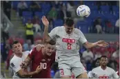  ?? RICARDO MAZALAN — THE ASSOCIATED PRESS ?? Switzerlan­d’s Remo Freuler, top, heads the ball past Serbia’s Dusan Tadic, center left, during a World Cup Group G match in Doha, Qatar, on Friday.