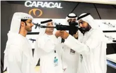  ?? Abdul Rahman/Gulf News ?? Targeting growth Hamad Salem Al Ameri demonstrat­es the Caracal assault rifle at the company’s pavilion yesterday. The company exports 30% of its products to countries in the Middle East.
