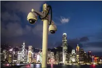  ?? LAM YIK FEI — THE NEW YORK TIMES ARCHIVES ?? Security cameras in Hong Kong. The Chinese government is gathering data on individual­s to see if they are considerin­g committing a crime.