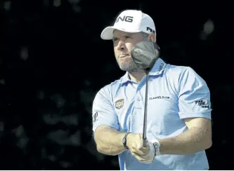  ?? JOHN BAZEMORE/THE ASSOCIATED PRESS ?? Lee Westwood, of England, watches his tee shot on the 12th hole during the first round of the PGA Championsh­ip golf tournament at the Quail Hollow Club in Charlotte, N.C. It’s not quite a badge of honour, though it beats the alternativ­e. Westwood was...