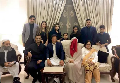  ?? AFP ?? Cricketer-turned-opposition leader and chief of the Pakistan Tehreek-i-Insaaf, Imran Khan, with his new wife Bushra Maneka and relatives during the nikah ceremony in Lahore. —