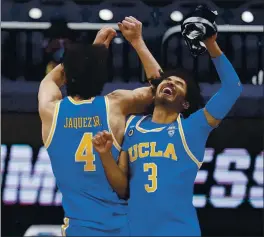  ?? MICHAEL CONROY – THE ASSOCIATED PRESS ?? UCLA’s Jaime Jaquez Jr., left, and Johnny Juzang celebrate following their 88-78 overtime win over Alabama in the Sweet 16 of the NCAA Tournament in Indianapol­is.