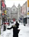  ??  ?? A woman checks her phone on an empty Dublin street. Photo: Clodagh Kilcoyne