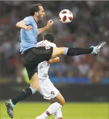  ?? Francois Nel / Getty Images ?? Uruguay’s Diego Godin, left, during Saturday’s match against Portugal in Sochi, Russia.