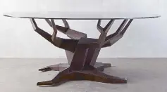  ??  ?? Inspired by nature: Steel, wood and glass Molave round dining table designed by Budji Layug