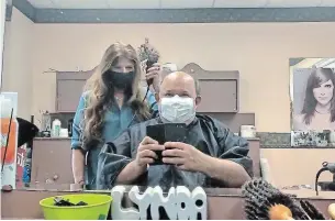  ?? BERRY VRBANOVIC ?? Kitchener Mayor Berry Vrbanovic gets a haircut after pandemic restrictio­ns were eased in Waterloo Region, allowing personal care settings to open their doors to customers again.