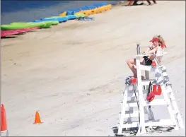  ??  ?? Lifeguard Angelique Allard keeps an eye on swimmers at Spring Lake Beach.