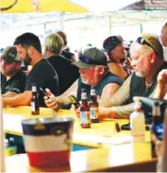  ?? AP PHOTO/STEPHEN GROVES ?? People crowd around a bar in Sturgis, S.D., on Friday during the 80th anniversar­y of the Sturgis Motorcyle Rally.