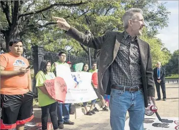  ?? Ricardo B. Brazziell Austin American-Statesman ?? OUTSIDE the governor’s mansion in Austin, teachers union President Ken Zarifis speaks at a protest against Texas’ new “sanctuary cities” ban. The law allows police to ask about immigratio­n status during routine stops.