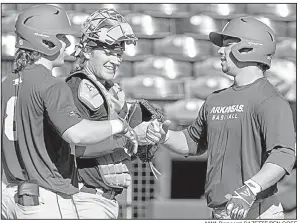  ?? NWA Democrat-GAZETTE/BEN GOFF ?? Arkansas center fielder Dominic Fletcher (right) celebrates with teammates Eric Cole (left) and Grant Koch after hitting a home run Saturday during a scrimmage at Baum Stadium in Fayettevil­le. The Razorbacks open their season at home Feb. 16 against...