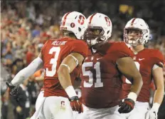  ?? Mathew Sumner / Associated Press ?? Michael Rector (left) celebrates his second-quarter touchdown reception with teammate Joshua Garnett at Stanford.