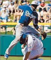  ?? Morry Gash Associated Press ?? DODGERS’ Dee Gordon lands on Chicago Cubs’ George Kottaras as Gordon turns a double play.