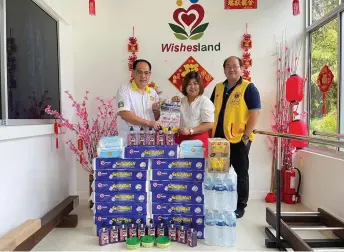  ?? ?? Jong (left) presents Lions Club of Batu Niah’s gifts of face masks, liquid hand wash, dishwashin­g paste, toilet rolls and drinks to Chai.