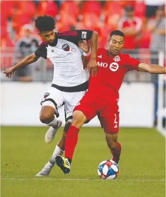  ?? MARK BLINCH/ THE CANADIAN PRESS ?? Fury’s Wal Fall battles Toronto FC’s Justin Morrow Wednesday during their Canadian Championsh­ip second-leg semifinal match in Toronto. The Reds won 3-0 to clinch the series.