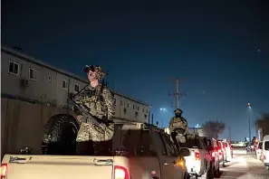  ?? AP Photo/Alex Brandon, File ?? In this Nov. 28, 2019, file photo armed soldiers stand guard in the motorcade for President Donald Trump speaks during a surprise Thanksgivi­ng Day visit to the troops at Bagram Air Field, Afghanista­n. Without coming right out and saying it, President Joe Biden seems ready to let lapse a May 1 deadline for completing a withdrawal of U.S. troops from Afghanista­n. Orderly withdrawal­s take time, and Biden is running out of it.