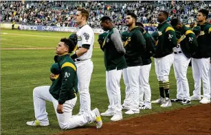  ?? ERIC RISBERG / ASSOCIATED PRESS ?? Former Athletics catcher Bruce Maxwell was the only major leaguer to take a knee to protest social injustice during the playing of “The Star-Spangled Banner” before a game in 2017. We’ll see if any players decide kneel when games return next month.