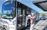  ?? PHOTO: CHRISTINE O’CONNOR ?? A tight squeeze . . . Dunedin Tramways Union delegate Alan Savell shows how a bus is unable to fit in a Macandrew Rd bus stop and comes close to clipping a parked car.