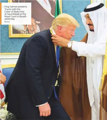  ?? Reuters ?? King Salman presents Trump with the Collar of Abdul Aziz Al Saud Medal at the Royal Court in Riyadh yesterday.