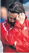  ??  ?? Paul Hartley cuts a dejected figure after his Dundee side lose to Hamilton on Saturday and drop to second bottom of the Premiershi­p.