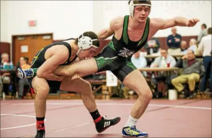  ?? NATE HECKENBERG­ER — FOR DIGITAL FIRST MEDIA ?? Pope John Paul’s Ryan Vulakh takes Methacton’s Roman Moser down on his way to a second-period technical fall in the 145-pound final.