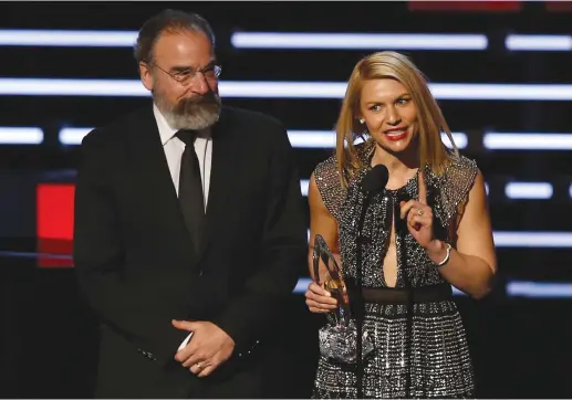  ?? (Mario Anzuoni/Reuters) ?? CLAIRE DANES accepts the award for favorite premium cable TV show with “Homeland” co-star Mandy Patinkin at the People’s Choice Awards 2016 in Los Angeles, in January 2016. Parts of the show were filmed in Israel but the show later canceled its Israel...