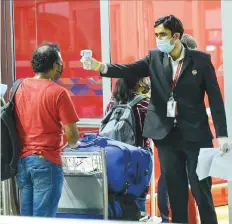  ?? PTI ?? ■
An Indian passenger gets thermal scanned as he arrives at the Delhi airport yesterday. India’s home affairs ministry said the airlines should ensure the passengers have no travel restrictio­ns to enter a country before issuing tickets.