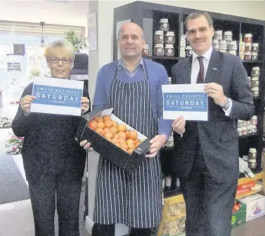  ??  ?? Business matters Tom Greatrex MP (right) with Bobby McKean and Isabel McLean, supporting Small Business Saturday last year