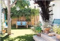  ??  ?? A TREE-SHADED deck is a relaxing getaway spot. Artificial grass was installed to make outdoor entertaini­ng easier.