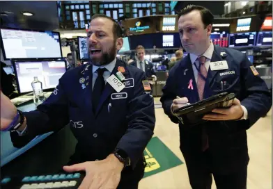  ?? AP Photo/Richard Drew ?? Markets: Specialist Michael Pistillo, left, and trader Brandon Barb work on the floor of the New York Stock Exchange, Monday, Feb. 5, 2018. Stock markets around the world took another pummeling Monday as investors continued to fret over rising U.S....