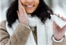  ?? ?? african american woman touching cheek and applying protective cream