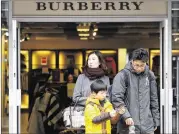  ?? FRANK AUGSTEIN / ASSOCIATED PRESS ?? Shoppers leave a Burberry store Friday in London. The post-Brexit vote’s devaluatio­n of the pound has made luxury goods in the United Kingdom far cheaper, and a draw for bargain-hunters.
